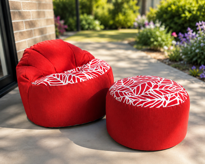 Red bean bag chair and ottoman with white leaf pattern on a patio