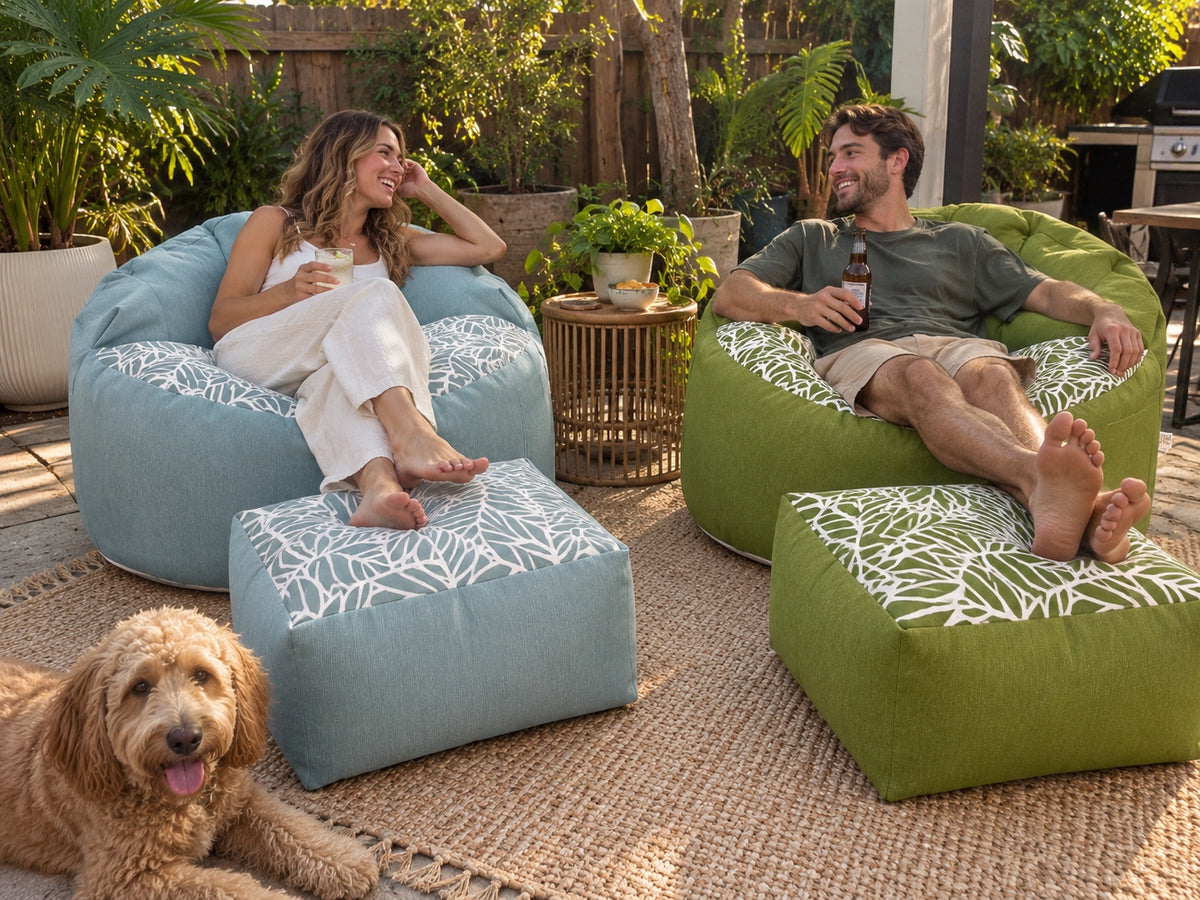 Outdoor patio with Lazy Beanz blue and green bean bag sets, a couple and a dog