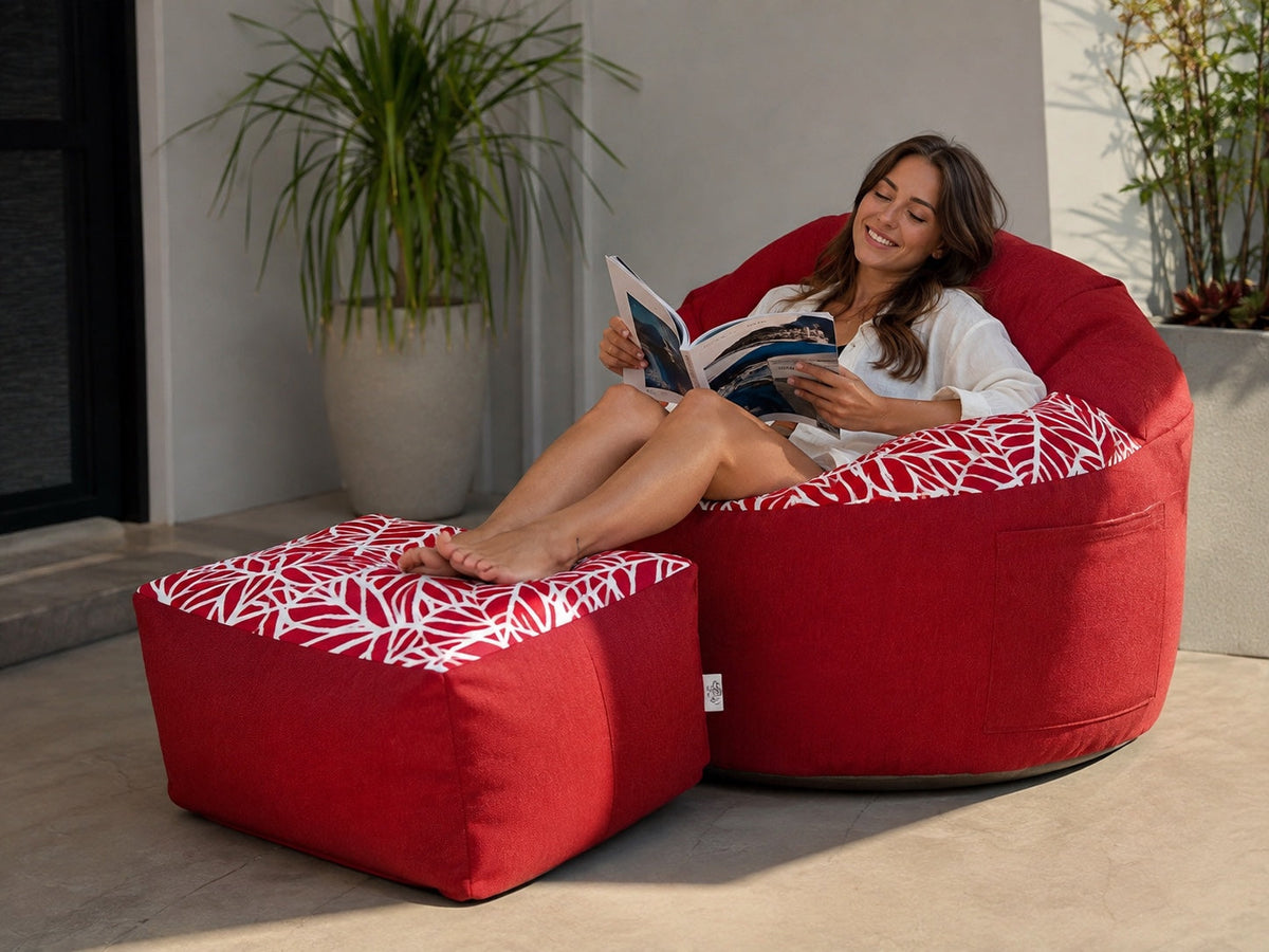 Woman relaxing on a Lazy Beanz Coral Reef Red adult bean bag and square ottoman set