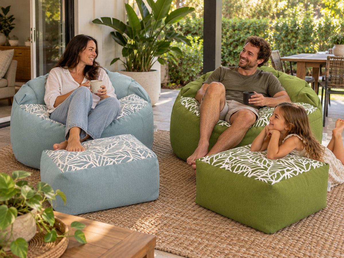 Family relaxing outdoors on Lazy Beanz blue and green bean bags with matching ottomans