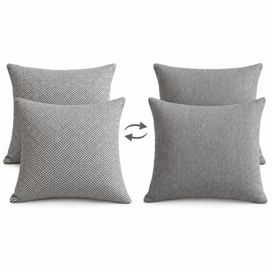 Aldinga Gull geometric front and Lomani Pumice grey reverse of two reversible cushions shown with flip arrows on white background