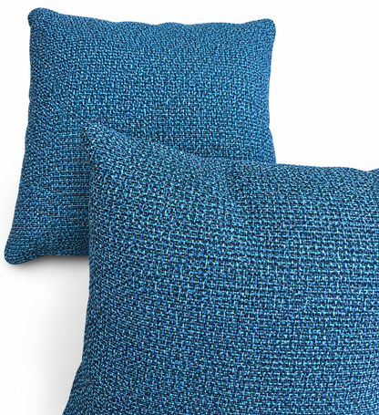 Two blue Kuata Lagoon woven 40x40 cm scatter cushions on white background