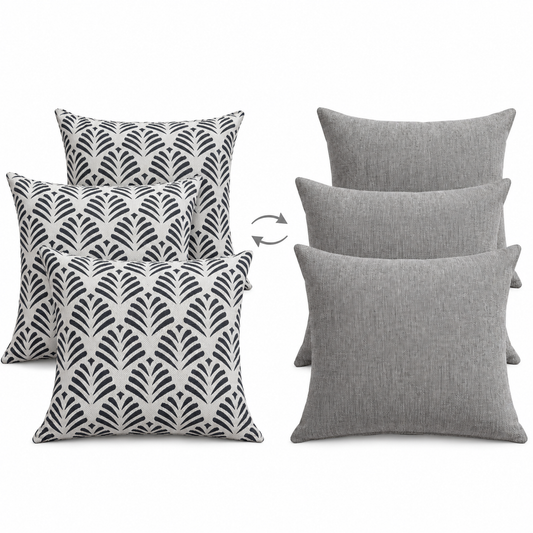Three 45x45 cm reversible cushions shown Sosa Navy patterned front to Lomani Pumice grey back with flip symbol on white background